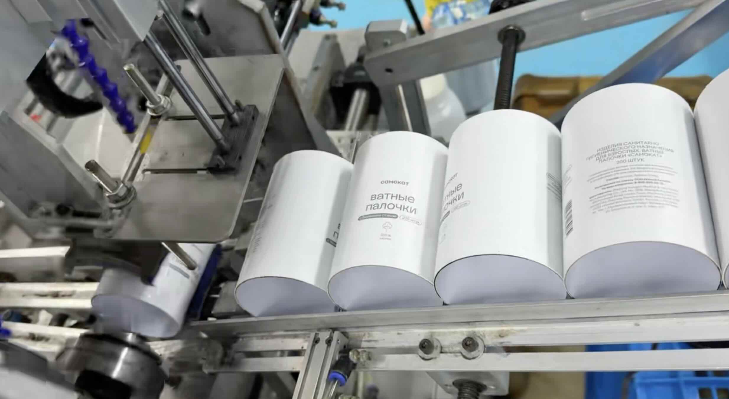 Paper tubes moving through production equipment inside the Earthycores factory